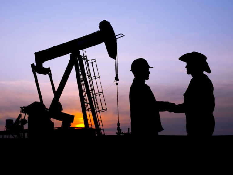 Oil Worker and Rancher Farmer Cooperating at Pumpjack